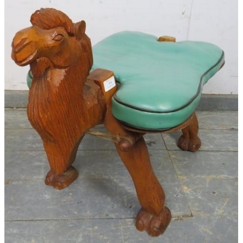 854 - A vintage teak camel stool, having loose cushion in green vinyl, on carved supports. 
H50cm W38cm D7... 