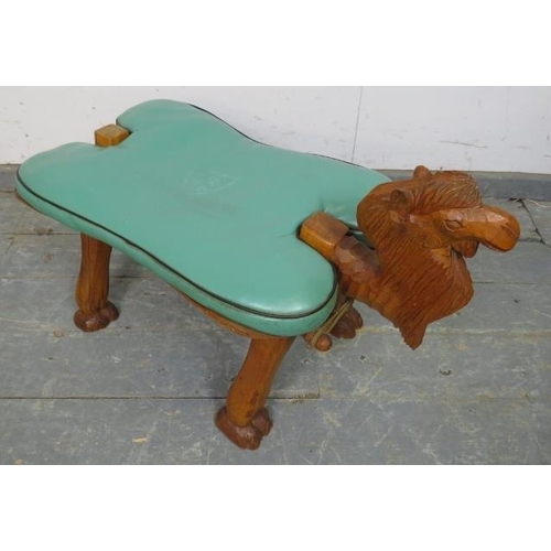 854 - A vintage teak camel stool, having loose cushion in green vinyl, on carved supports. 
H50cm W38cm D7... 