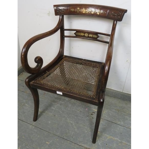 855 - A Regency Period mahogany sabre leg elbow chair, the carved back with brass inlay, joined with scrol... 