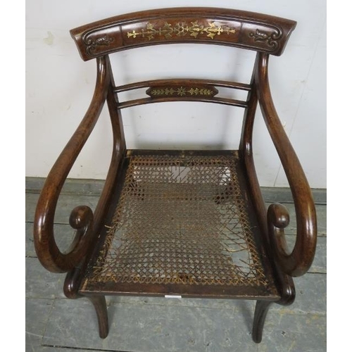 855 - A Regency Period mahogany sabre leg elbow chair, the carved back with brass inlay, joined with scrol... 