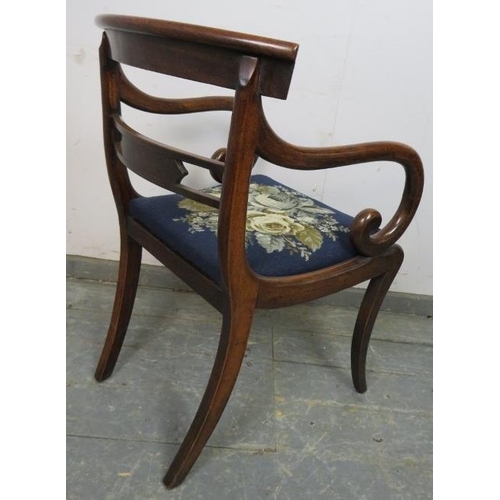 855 - A Regency Period mahogany sabre leg elbow chair, the carved back with brass inlay, joined with scrol... 