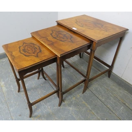 857 - A nest of three antique walnut graduated tables, the quarter veneered tops on turned supports with s... 