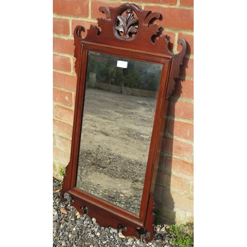 858 - An antique mahogany bevelled wall mirror in the Georgian taste, the carved and pierced surround with... 