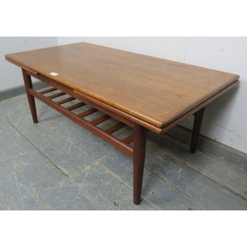 859 - A mid-century Danish teak coffee table by Trioh, having draw-leaf extending sides, on turned support... 