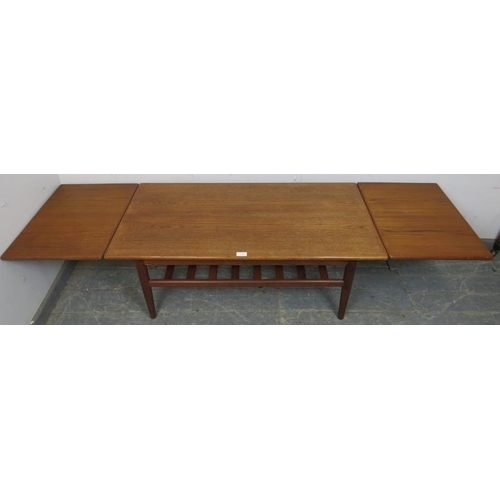 859 - A mid-century Danish teak coffee table by Trioh, having draw-leaf extending sides, on turned support... 