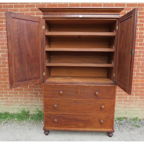 861 - A Victorian mahogany linen press of good colour, the moulded cornice above panelled doors opening on... 