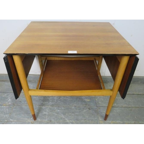 862 - A mid-century teak drop-leaf two-tier table, with chamfered and ebonised edge above a galleried unde... 