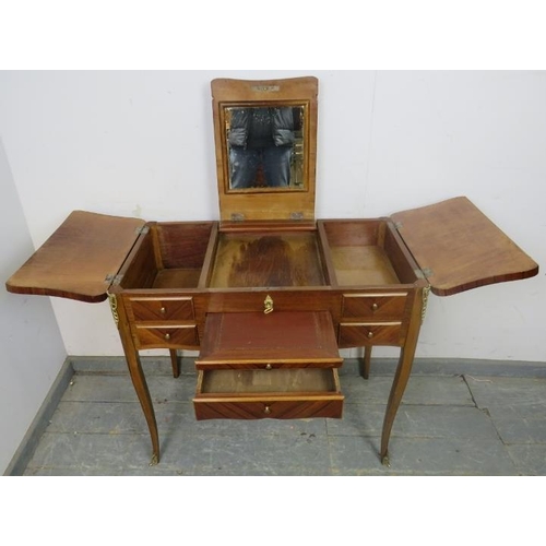 863 - A vintage French mahogany and tulipwood dressing table with gilt brass mounts, the rising central mi... 