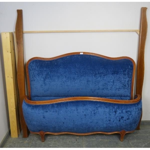 865 - An antique style French fruitwood king-size bed, the head and footboards upholstered in Royal blue c... 