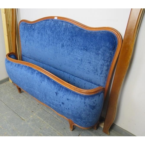 865 - An antique style French fruitwood king-size bed, the head and footboards upholstered in Royal blue c... 