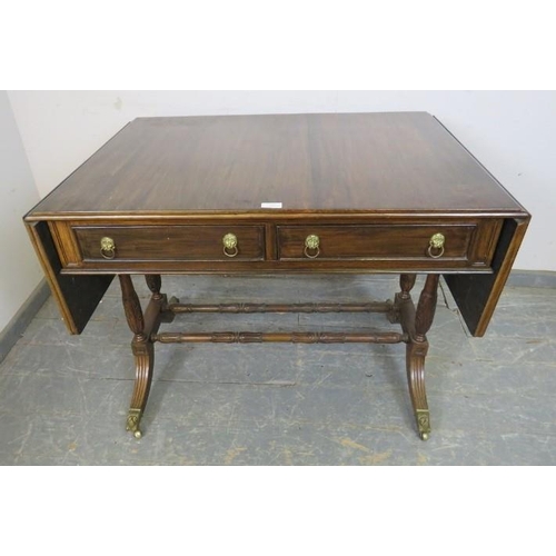 866 - A vintage mahogany sofa table in the Regency taste, having short cock-beaded drawers with gilt brass... 