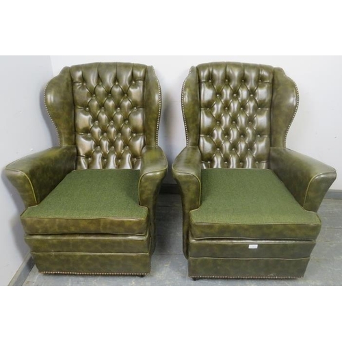 867 - A pair of vintage Chesterfield style wingback armchairs, upholstered in faux green leather with bras... 