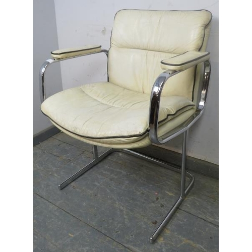 868 - A mid-century desk chair in the manner of Peiff, upholstered in cream leather with black piping, on ... 