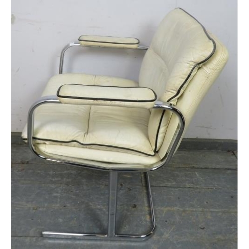 868 - A mid-century desk chair in the manner of Peiff, upholstered in cream leather with black piping, on ... 