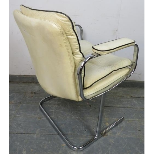 868 - A mid-century desk chair in the manner of Peiff, upholstered in cream leather with black piping, on ... 