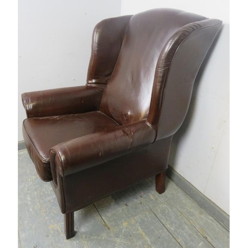 870 - An antique style wingback armchair, upholstered in brown leather, on reeded square supports.
H115cm ... 