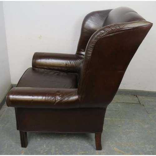 870 - An antique style wingback armchair, upholstered in brown leather, on reeded square supports.
H115cm ... 