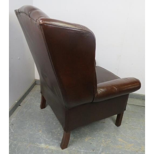 870 - An antique style wingback armchair, upholstered in brown leather, on reeded square supports.
H115cm ... 