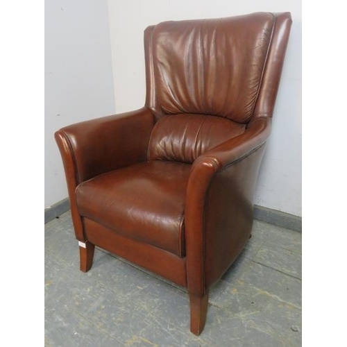 872 - A contemporary armchair, upholstered in tobacco brown leather, on sabre legs. 
H98cm W72cm D76cm (ap... 