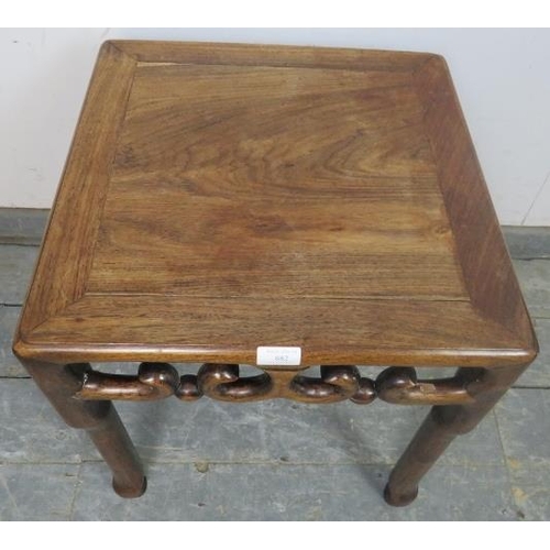 882 - A vintage Chinese hardwood occasional table with carved and pierced frieze decoration, on shaped sup... 