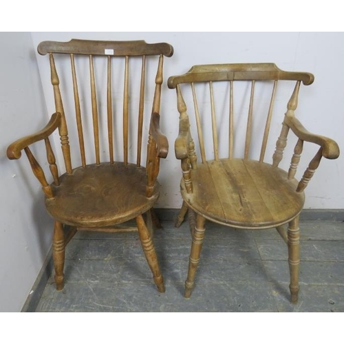 884 - A matched pair of antique elm and beech His & Hers penny elbow chairs, on canted turned supports wit... 