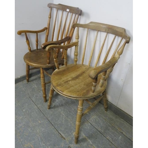 884 - A matched pair of antique elm and beech His & Hers penny elbow chairs, on canted turned supports wit... 