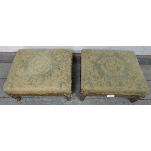 891 - A pair of Regency Period giltwood footstools, retaining the original upholstery, on fluted supports ... 