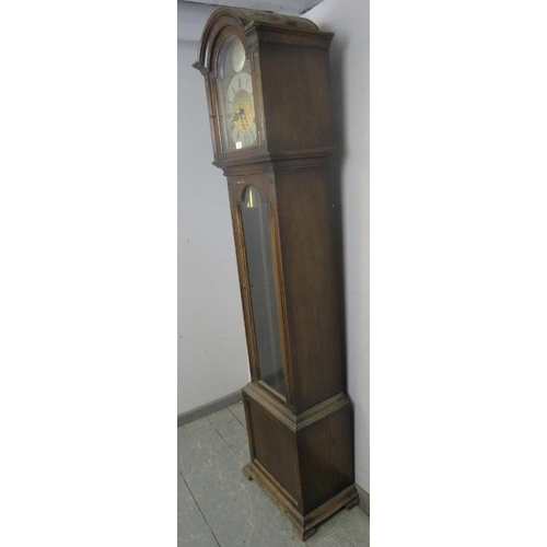 893 - A vintage oak cased ‘Tempus Fugit’ chiming longcase clock, the arched dial enclosed by ornate brass ... 