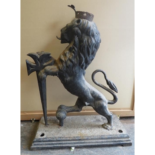 894A - A large antique cast iron armorial figure of a crowned rampant lion with sword, on a plinth base. H8... 