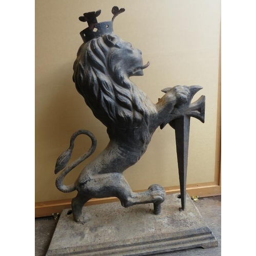 894A - A large antique cast iron armorial figure of a crowned rampant lion with sword, on a plinth base. H8... 