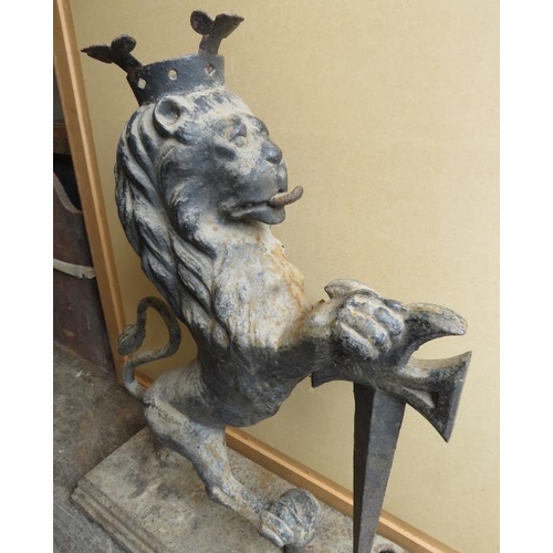 894A - A large antique cast iron armorial figure of a crowned rampant lion with sword, on a plinth base. H8... 