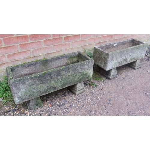 895A - A pair of weathered reconstituted stone trough planters, with relief decoration, on chamfered block ... 