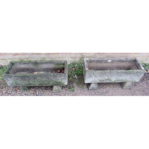 895A - A pair of weathered reconstituted stone trough planters, with relief decoration, on chamfered block ... 