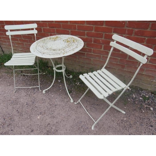 897 - A vintage painted metal circular garden table, the slatted top above scrolled frieze decoration, on ... 