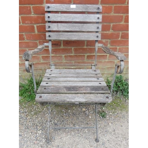 898 - A weathered teak folding garden elbow chair with slatted seat. 
H90cm W59cm D81cm (approx).
Conditio... 