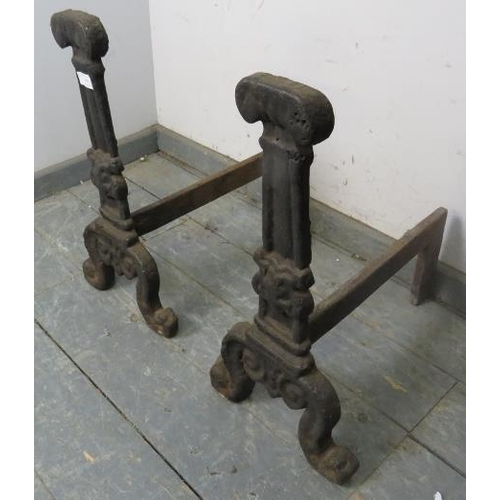 899 - A pair of antique cast iron fire dogs, probably 17th century, on scrolled supports. 
H55cm W28cm D46... 