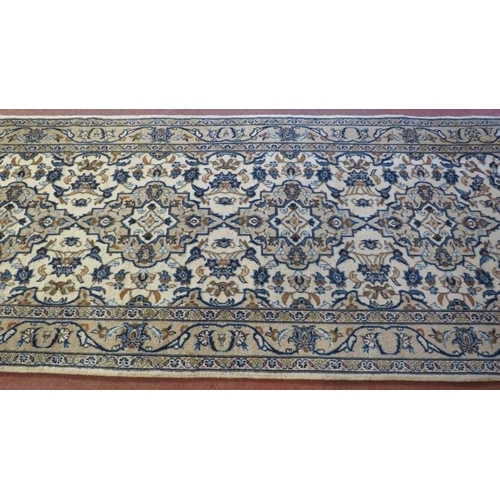 901 - A central Persian Kashan runner, four central motifs on a cream ground. 300cm x 100cm (approx).
Cond... 