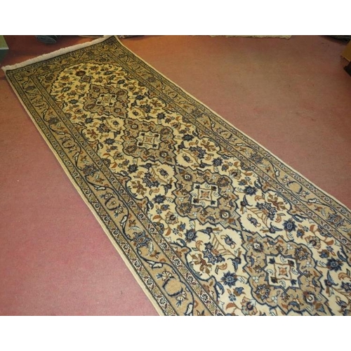 901 - A central Persian Kashan runner, four central motifs on a cream ground. 300cm x 100cm (approx).
Cond... 