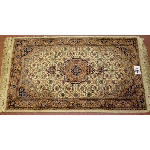 907 - A Persian design rug, central motif, surrounded by repeat fawn, cream & brown. 176cm x 94cm (approx)... 