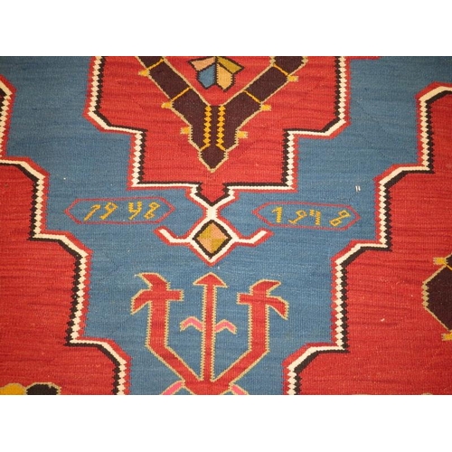 909 - A large 20th century Armenian Kilim rug, vibrant colours, blue on burnt amber field. 340cm x 161cm (... 