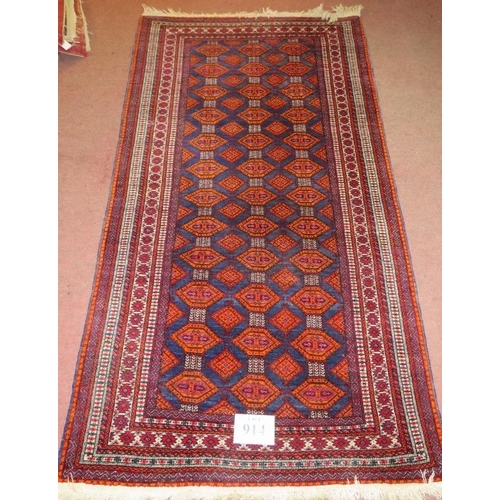 914 - A 20th century Persian rug, central field of repeat pattern, orange/red on blue ground. 180cm x 96cm... 