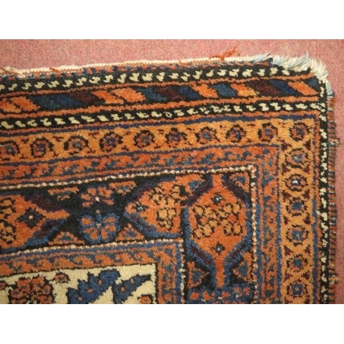 918 - A mid/late 20th century Persian rug, central pattern design in cream, black, blue & brown. 177cm x 1... 