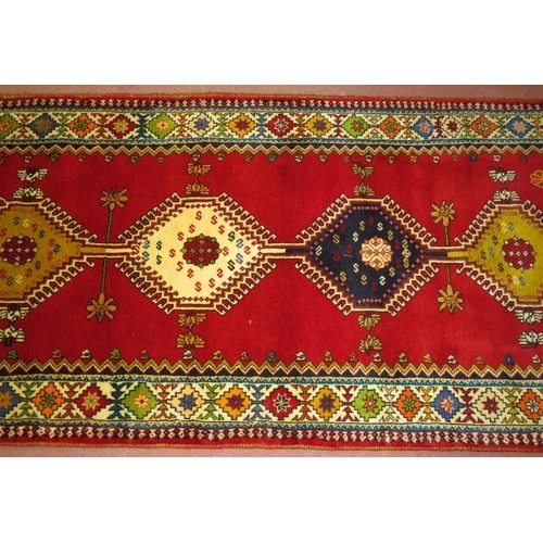 926 - South West Persian Qashgai runner, central motifs, mustard, blue & cream on a red ground. 250cm x 98... 