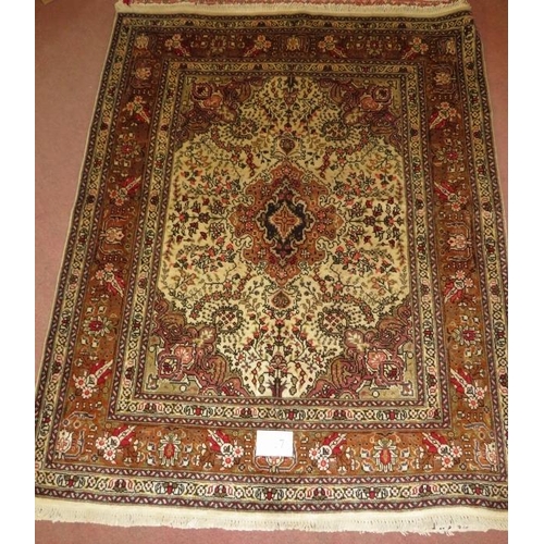 927 - North West Persian Tabriz rug, central motif surrounded by foliage on cream/brown field. 182cm x 148... 