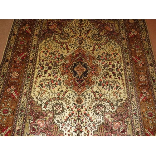 927 - North West Persian Tabriz rug, central motif surrounded by foliage on cream/brown field. 182cm x 148... 