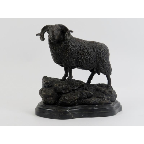 113 - A bronze metal figure of a ram on a rocky outcrop, 20th century. Supported on a marble base. 21.3 cm... 