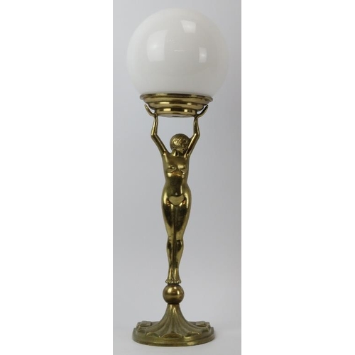 151 - An Art Deco gilt brass ‘Diana’ table lamp, early 20th century. With later added spherical glass shad... 