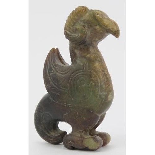 16 - A Chinese archaistic jade carving of a zoomorphic creature. Formed as a bird with rams horns, incise... 