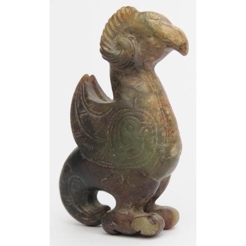 16 - A Chinese archaistic jade carving of a zoomorphic creature. Formed as a bird with rams horns, incise... 