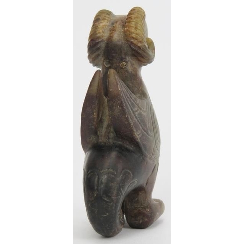 16 - A Chinese archaistic jade carving of a zoomorphic creature. Formed as a bird with rams horns, incise... 